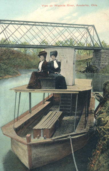 Two women sitting on a boat on the Washita River
